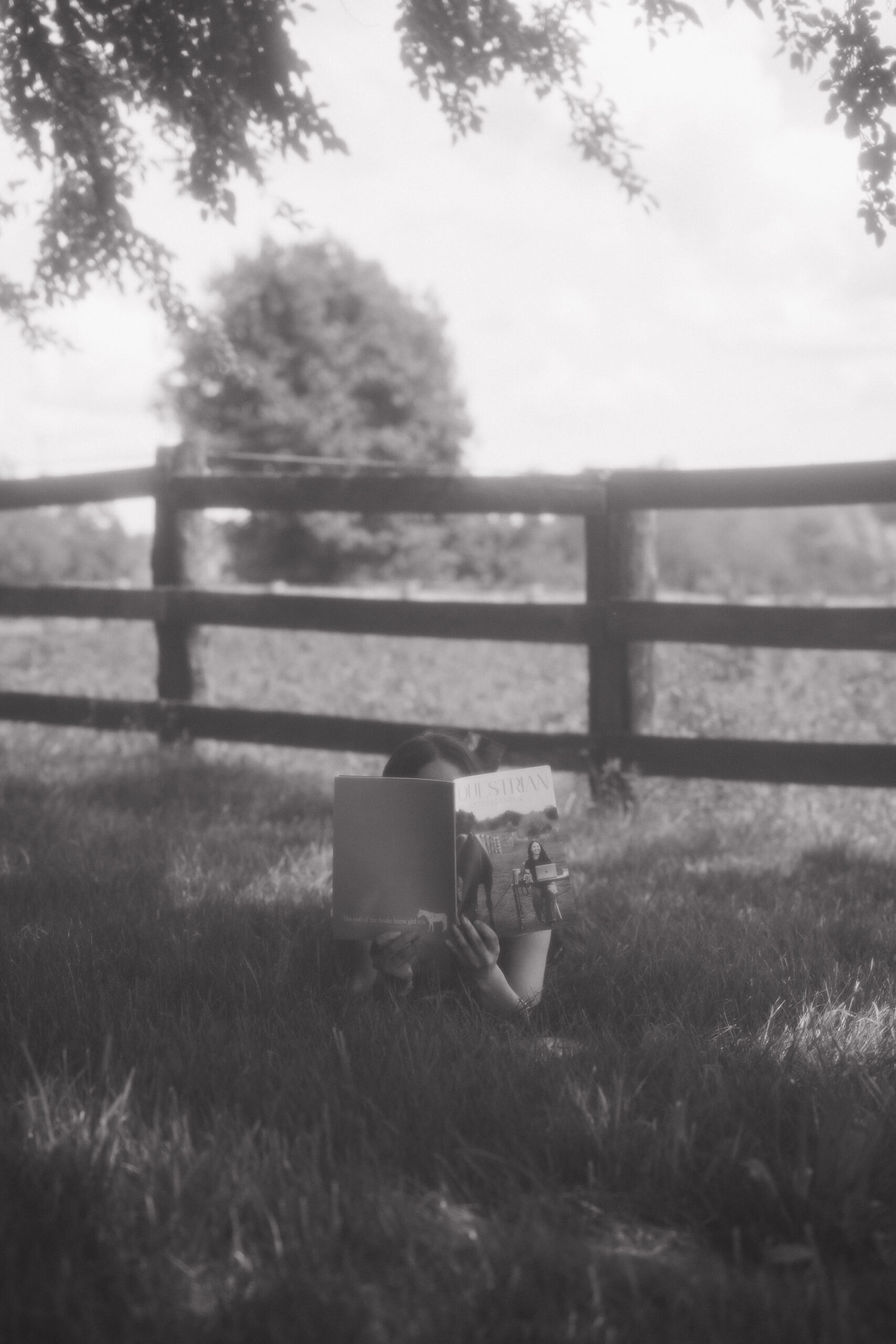 Reading under a blackberry tree in dress pants and riding boots